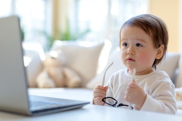 Little toddler boy with a laptop computer