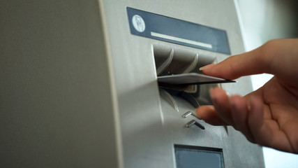 ATM reader taking credit card and returning it after identification, security