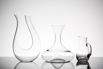 Three different glass decanters on a white background