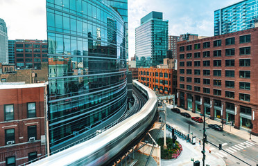 An elevated train curving through Downtown Chicago