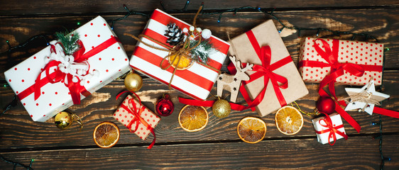 Christmas gifts with decoration on a wooden board.