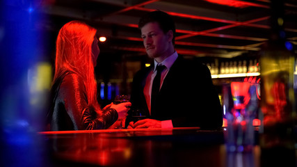 Woman talking with man, communicating in nightclub, acquaintance and flirt