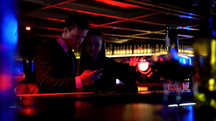 Happy couple having fun in bar together, youth entertainment, night life