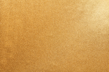 Golden glitter background. Golden glitter for Christmas gift concept design. Abstract background with highlight spot at top right corner.