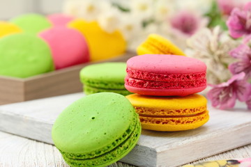 Colorful macaroons on wooden table. Sweet dessert