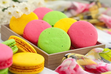 Colorful macaroons on wooden table. Sweet dessert