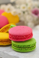 Colorful macaroons on wooden table. Sweet dessert