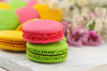 Colorful macaroons on wooden table. Sweet dessert
