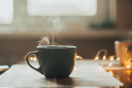 Hot Tea Cup On A Frosty Winter Day Window Background. Vertical Photo