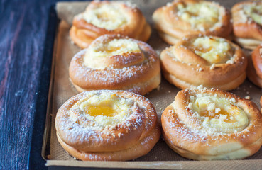 Obraz na płótnie Canvas Homemade buns with ricotta and jam on a baking sheet.