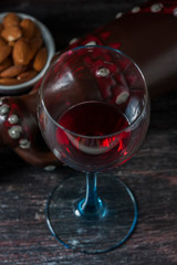 Ceramic jug for wine , cheese, nuts on a wooden board, background.