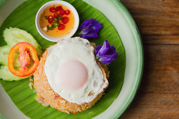 Fried rice with Fried egg pork, Cucumber and tomato on plate. top view