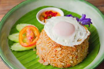 Fried rice with Fried egg pork, Cucumber and tomato on plate. top view