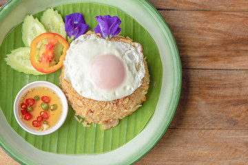 Fried rice with Fried egg pork, Cucumber and tomato on plate. top view