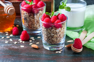Healthy breakfast. Granola with honey, yogurt and fresh berries raspberry in a glass.