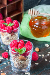 Healthy breakfast. Granola with honey, yogurt and fresh berries raspberry in a glass.