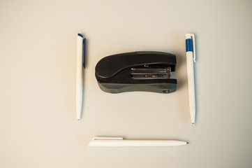 Black isolated stapler and a pen composition