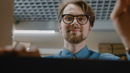 View from Inside Cardboard Package Box: Warehouse Worker Carefully Packs / Takes Out Product for...