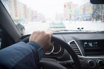 driving a car in the winter on the city street