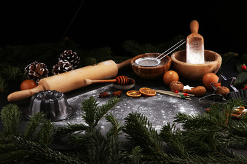 Baking ingredients for homemade pastry on wooden background with cookies and spieces