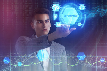 The concept of business, technology, the Internet and the network. A young entrepreneur working on a virtual screen of the future and sees the inscription: Governance