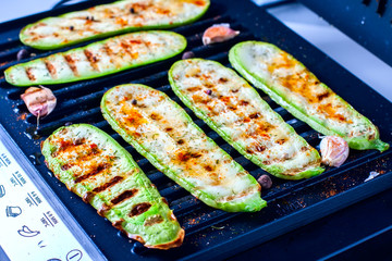 Grilled zucchini on a grill close-up.
