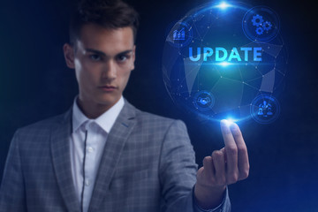 The concept of business, technology, the Internet and the network. A young entrepreneur working on a virtual screen of the future and sees the inscription: Update