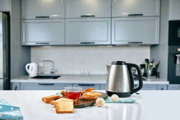 A cup of black tea with Sandwiches or toasts on white table.