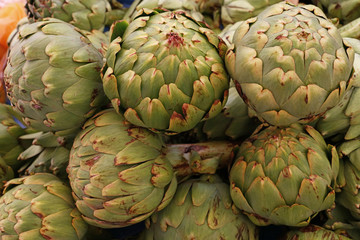 Fototapeta premium Green fresh globe artichokes on market stall