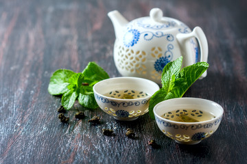 Chinese tea set, green tea and fresh mint.