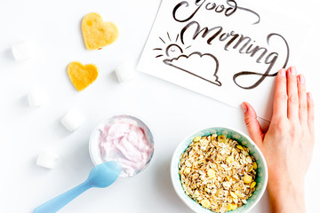 concept kid breakfast with yogurt top view white background