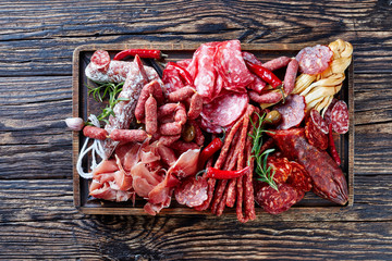 set of meat appetizer on a wooden board