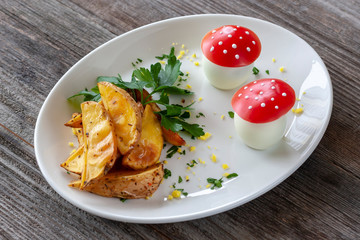 Vegetarian dish: Baked potatoes with greens and boiled eggs in the form of fly-agaric.