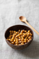 Spicy roasted chickpeas in coconut bowl
