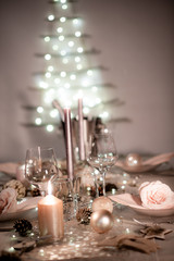 christmas eve party table with wine glass and glitter season's greeting decoration