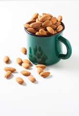 Almonds in a bowl isolated on white background. Healthy snack.
