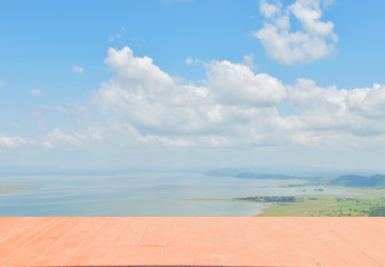 Fototapeta premium There is wooden balcony front the lake with cloud in blue sky.