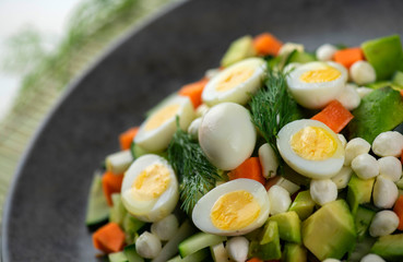 Fresh vegetable salad with quail eggs
