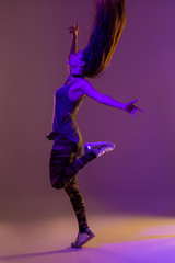 Modern style dancer posing on studio background. Color filters