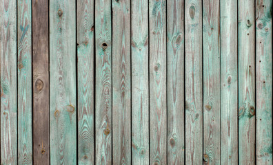 The old wooden walls painted green. Old wooden wall background or texture.