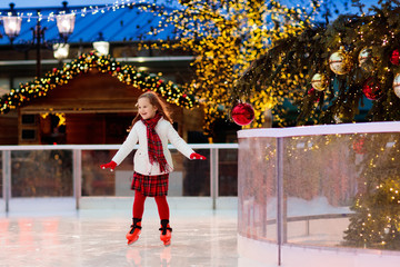 Kids ice skating in winter. Ice skates for child.