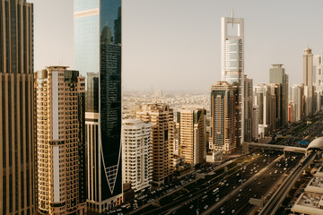 Beautiful aerial panoramic view to Dubai downtown city center skyline and Sheikh Zayed Road in the sunset, United Arab Emirates