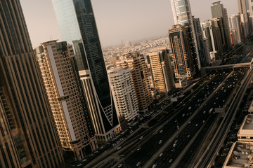 Fototapeta premium Beautiful aerial panoramic view to Dubai downtown city center skyline and Sheikh Zayed Road in the sunset, United Arab Emirates