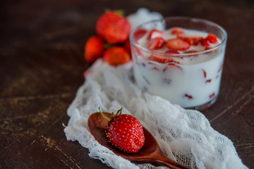 Strawberries and milk in a glass Cup. the concept of a light summer dessert.