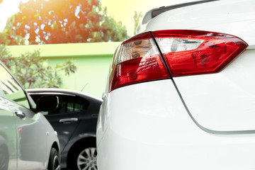 The rear of a white car in a garage.