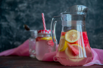 Lemonade watermelon and lemon in a glass carafe. The concept of a refreshing drink in the summer.
