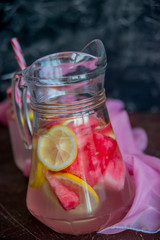 Lemonade watermelon and lemon in a glass carafe. The concept of a refreshing drink in the summer.