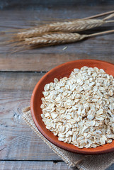 oat flakes on wooden table. healthy food concept.