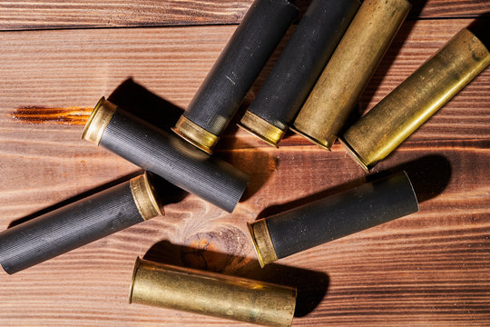 Hunting shells and 12 gauge cartridges on wooden background