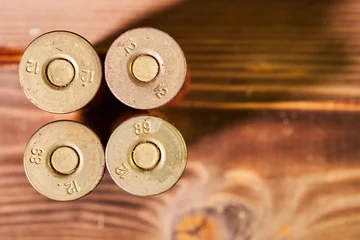 Rolgordijnen Hunting shells and 12 gauge cartridges on wooden background © Vitalii Makarov